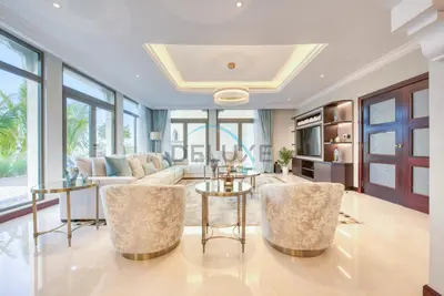 a living room with a couch and a table at Immaculate 4BR Villa with Assistant Room and Private Pool at Frond O Palm Jumeirah by Deluxe Holiday Homes in Dubai