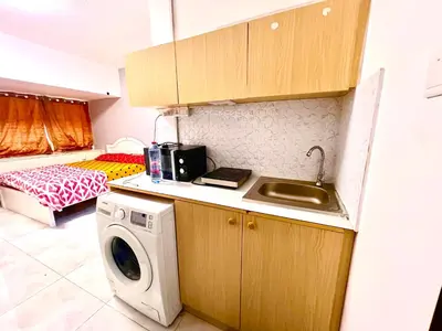 a kitchen with a sink and a washing machine at Flats in Dubai Emirates Tower Metro Station in Dubai