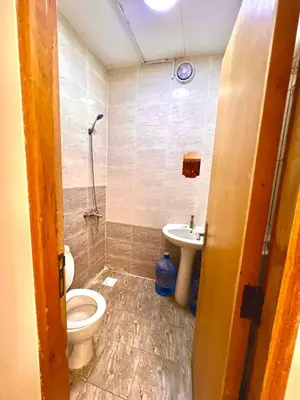 a bathroom with a toilet and a sink at Flats in Dubai Emirates Tower Metro Station in Dubai