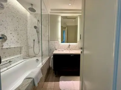 a bathroom with a tub and a sink and a shower at ElevenSisters in Dubai