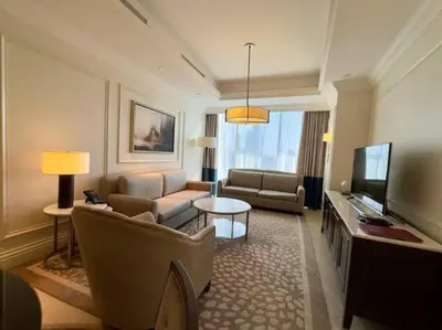 a living room with a couch and a television at ElevenSisters in Dubai
