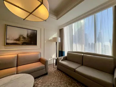 a living room with a couch and a large window at ElevenSisters in Dubai