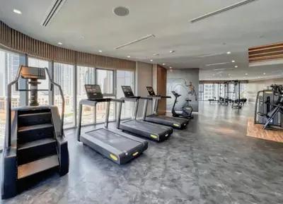 a gym with treadmills and ellipticals in a room at Spectacular 2 Bed Downtown I Highest Infiniti Pool in Dubai