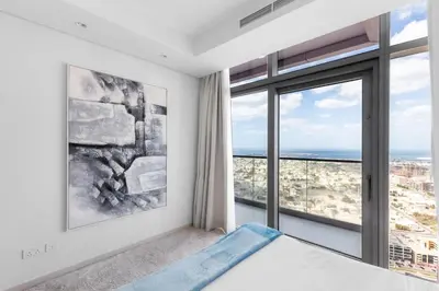 a bedroom with a bed and a large window at Spectacular 2 Bed Downtown I Highest Infiniti Pool in Dubai