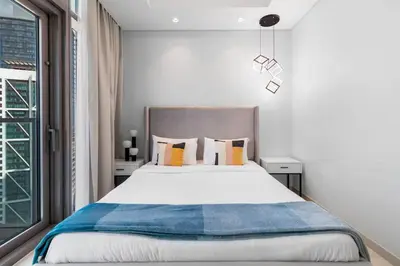 a bedroom with a large bed and a window at Spectacular 2 Bed Downtown I Highest Infiniti Pool in Dubai