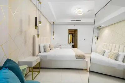 a bedroom with a bed and a glass wall at Spectacular 2 Bed Downtown I Highest Infiniti Pool in Dubai