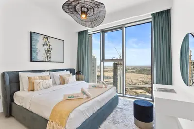 a bedroom with a large bed and a large window at Luxe Living in 1 Bedroom apartment at 17 Icon Bay in Dubai