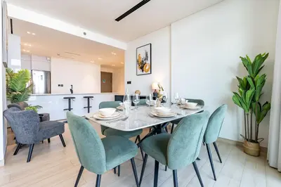 a dining room with a table and chairs at Spacious 2 Bedroom in JVC with pool & gym access in Dubai
