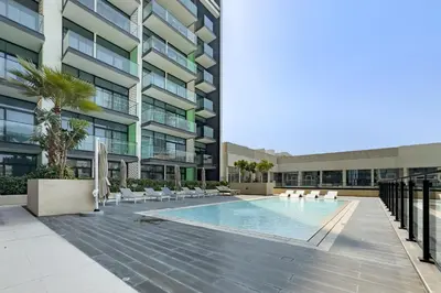a swimming pool in the courtyard of a building at Spacious 2 Bedroom in JVC with pool & gym access in Dubai