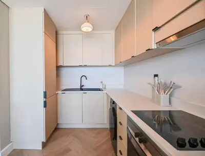 a kitchen with white cabinets and a sink at Casa Bouclé An Urban sanctuary in DIFC 1BR in Dubai