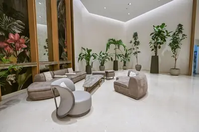 a living room with couches and chairs and potted plants at Casa Bouclé An Urban sanctuary in DIFC 1BR in Dubai