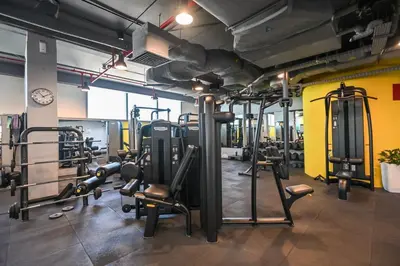 a gym with several treadmills and machines at Casa Bouclé An Urban sanctuary in DIFC 1BR in Dubai