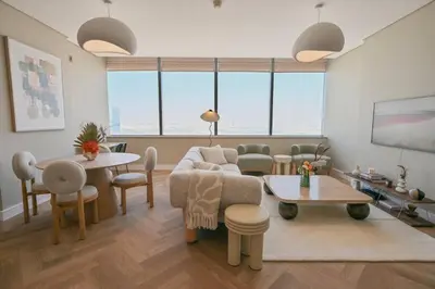 a living room with a couch and a table at Casa Bouclé An Urban sanctuary in DIFC 1BR in Dubai