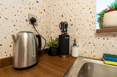 a kitchen counter with a coffee maker and a sink at White Sage Renovated Studio Nxt to Metro in Dubai
