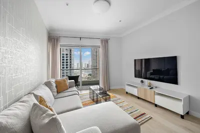 a living room with a couch and a tv at Spacious 1 BHK in Marina Heights in Dubai