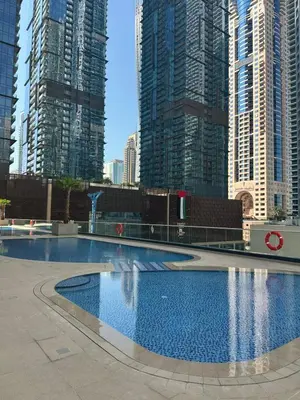 a large swimming pool in a city with tall buildings at Spacious 1 BHK in Marina Heights in Dubai