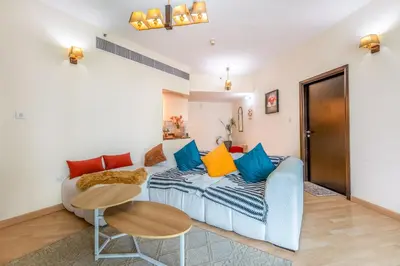 a living room with a couch and a table at Luxurious 2BR in Dubai Marina next to metro in Dubai