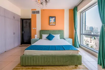 a bedroom with a bed and a large window at Luxurious 2BR in Dubai Marina next to metro in Dubai