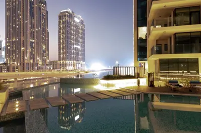 a pool in the middle of a city with tall buildings at Lusso Hometels Missoni Business Bay in Dubai