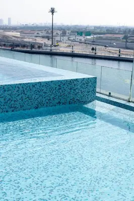 a swimming pool with blue water and a view at Lusso Hometels Missoni Business Bay in Dubai