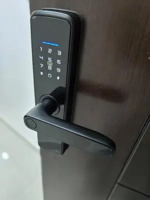 a close up of a door handle with a cell phone at Modern Studio Apartment in JVC, behind Circle Mall in Dubai