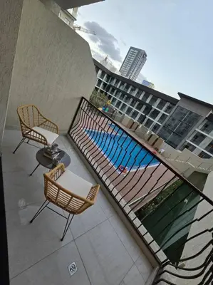 a balcony with a swimming pool on a building at Modern Studio Apartment in JVC, behind Circle Mall in Dubai