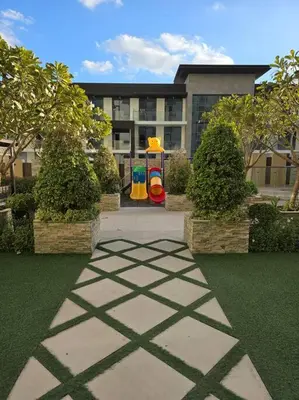 a park with a playground in front of a building at Modern Studio Apartment in JVC, behind Circle Mall in Dubai