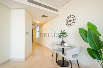 a dining room with a table and two chairs at Lively Studio in Sky Gardens, DIFC by Deluxe Holiday Homes in Dubai