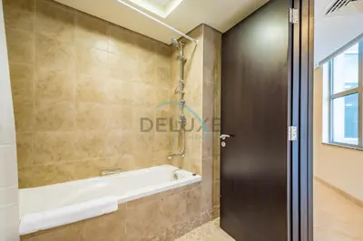 a bathroom with a tub and a shower stall at Lively Studio in Sky Gardens, DIFC by Deluxe Holiday Homes in Dubai