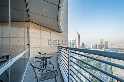 a balcony with a table and chairs on a building at Lively Studio in Sky Gardens, DIFC by Deluxe Holiday Homes in Dubai
