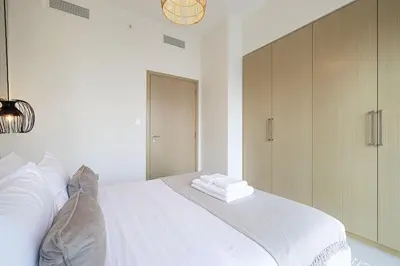 a bedroom with a white bed with towels on it at BURJ ROYALE - Luxurious Two-Bedroom apartment in DOWNTOWN, Burj Khalifa view POOL in the building, 5-min walk to Dubai Mall & Dubai Fountains in Dubai