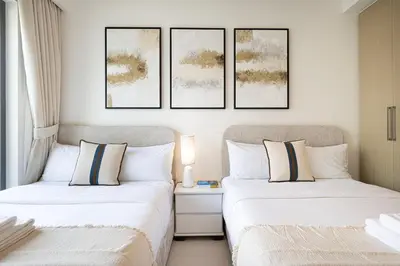 two beds sitting next to each other in a bedroom at BURJ ROYALE - Luxurious Two-Bedroom apartment in DOWNTOWN, Burj Khalifa view POOL in the building, 5-min walk to Dubai Mall & Dubai Fountains in Dubai