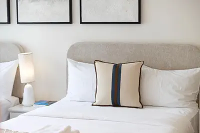 a bedroom with a bed with white pillows at BURJ ROYALE - Luxurious Two-Bedroom apartment in DOWNTOWN, Burj Khalifa view POOL in the building, 5-min walk to Dubai Mall & Dubai Fountains in Dubai
