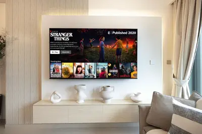 a living room with a tv hanging on a wall at BURJ ROYALE - Luxurious Two-Bedroom apartment in DOWNTOWN, Burj Khalifa view POOL in the building, 5-min walk to Dubai Mall & Dubai Fountains in Dubai