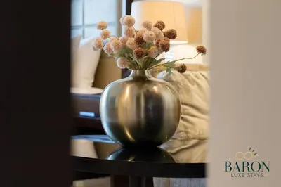 a vase with flowers in it sitting on a table at The Modern in Dubai