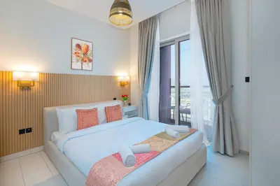 a bedroom with a bed and a large window at Modern 1br Oasis in Sobha Creek Vista A, MBR City - Allsopp & Allsopp in Dubai