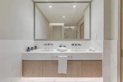a bathroom with two sinks and a large mirror at Luxury Palm Tower Studio Apartments with Pool and Fantastic Sea View in Dubai