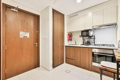 a kitchen with a wooden door and a counter top at Amazing 1BR APT with Burj Khalifa Views in Dubai
