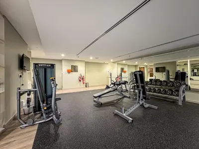 a gym with several treadmills and cardio machines at Amazing 1BR APT with Burj Khalifa Views in Dubai