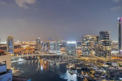 a view of a city at night at Amazing 1BR APT with Burj Khalifa Views in Dubai