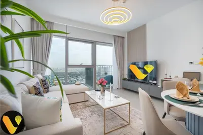 a living room with white furniture and a large window at Vogue Downtown Views II with Direct Access to Dubai Mall Via a Climate Controlled Bridge, One Bedroom Apartment with Balcony and City View in Dubai