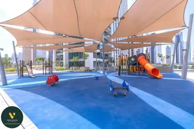 an image of a playground with an umbrella at Vogue Downtown Views II with Direct Access to Dubai Mall Via a Climate Controlled Bridge, One Bedroom Apartment with Balcony and City View in Dubai