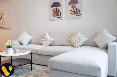 a living room with a couch and a table at Vogue Downtown Views II with Direct Access to Dubai Mall Via a Climate Controlled Bridge, One Bedroom Apartment with Balcony and City View in Dubai