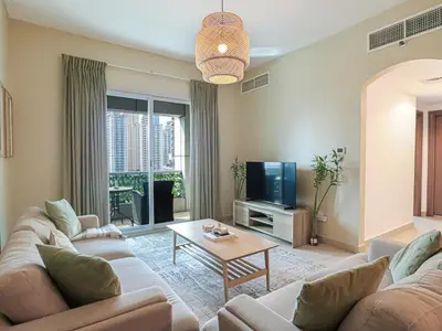 a living room with a couch and a tv at Near Metro & Tram 2bed Dubai Marina Close To Jbr! in Dubai