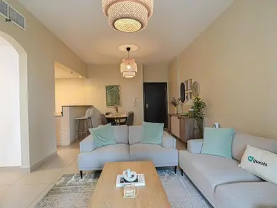 a living room with a couch and a table at Near Metro & Tram 2bed Dubai Marina Close To Jbr! in Dubai
