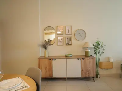 a dining room with a table and a mirror at Near Metro & Tram 2bed Dubai Marina Close To Jbr! in Dubai