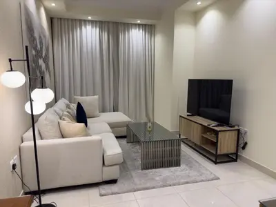a living room with a white couch and a television at 1BHK in Business Bay near metro in Dubai