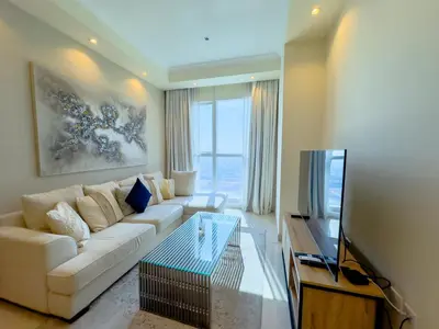 a living room with a white couch and a tv at 1BHK in Business Bay near metro in Dubai