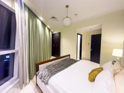 a bedroom with a bed and a large window at 1BHK in Business Bay near metro in Dubai