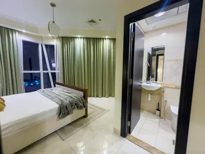 a bedroom with a bed and a bathroom at 1BHK in Business Bay near metro in Dubai